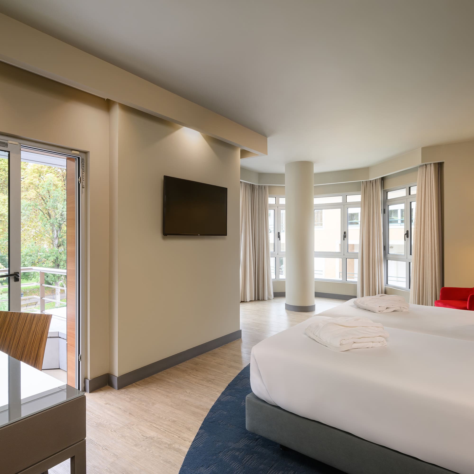 a room with two beds and a television