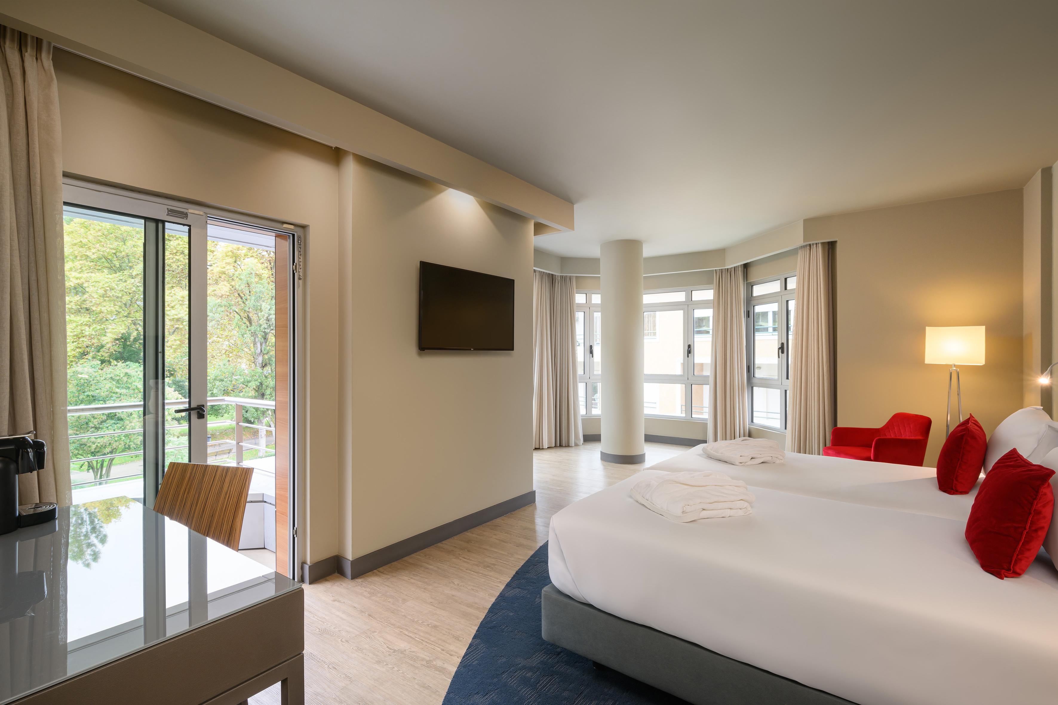a room with two beds and a television