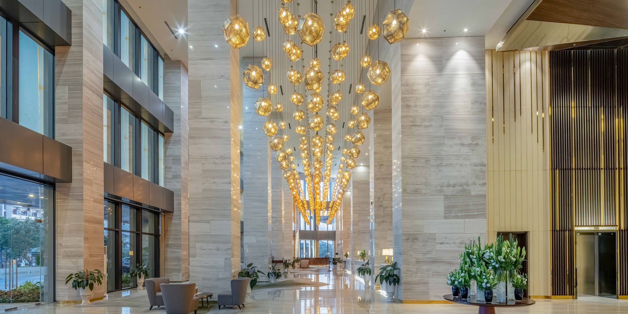 a large lobby with chandeliers and chairs