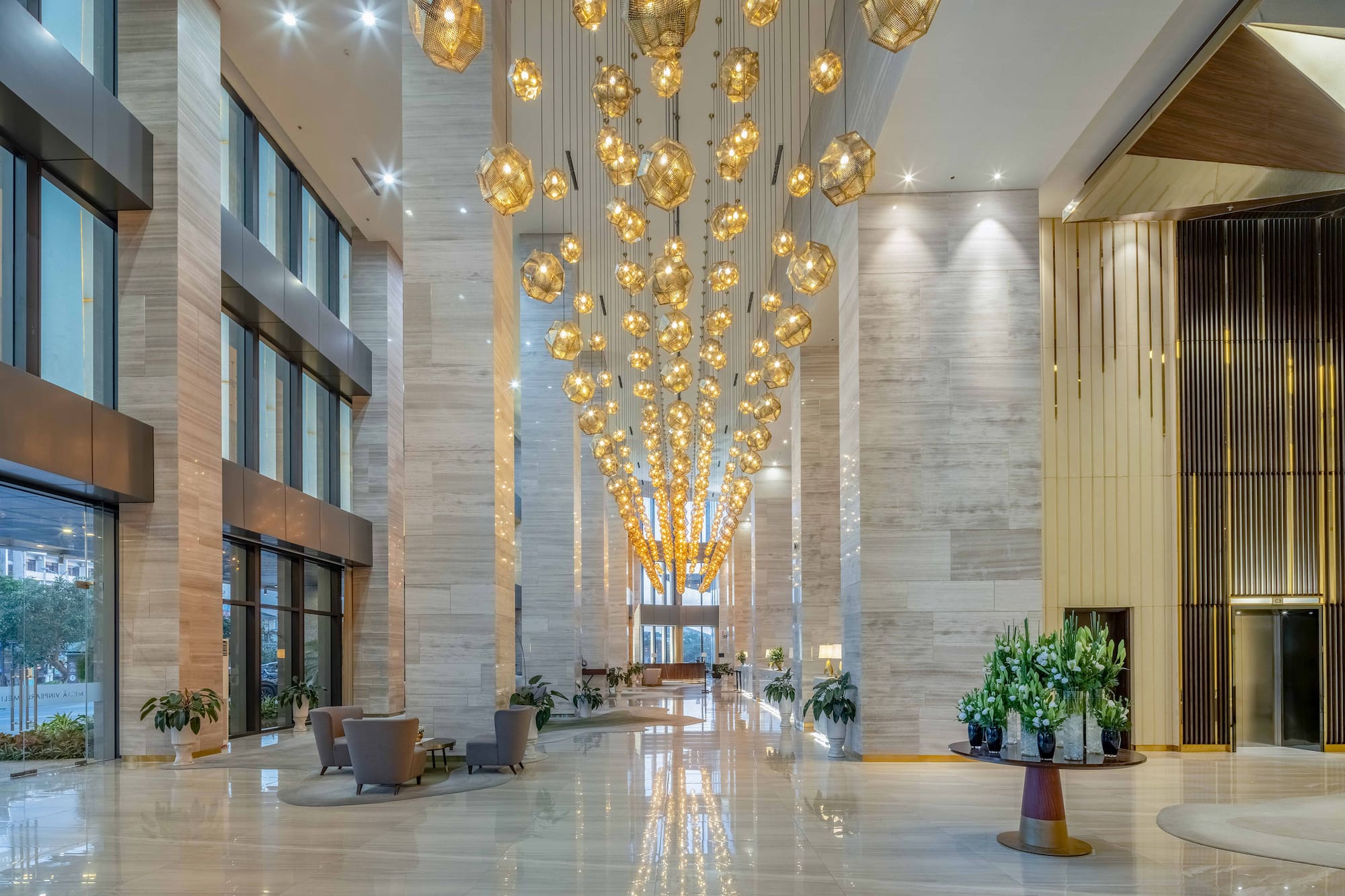 a large lobby with chandeliers and chairs