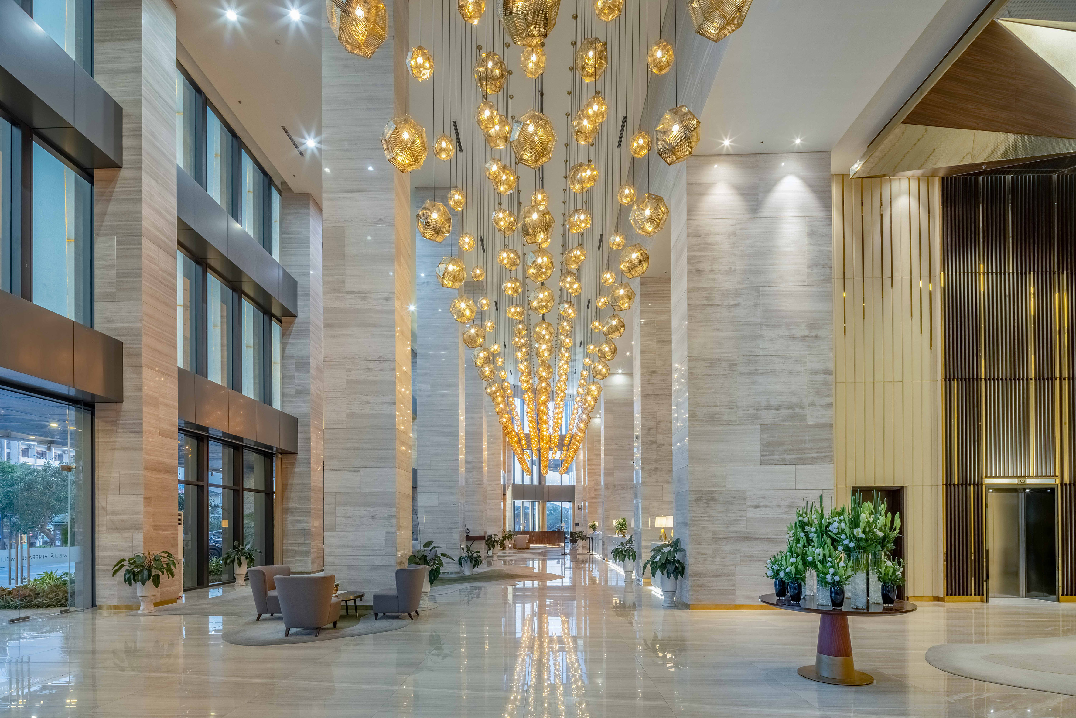 a large lobby with chandeliers and chairs