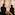 a group of people looking at a painting