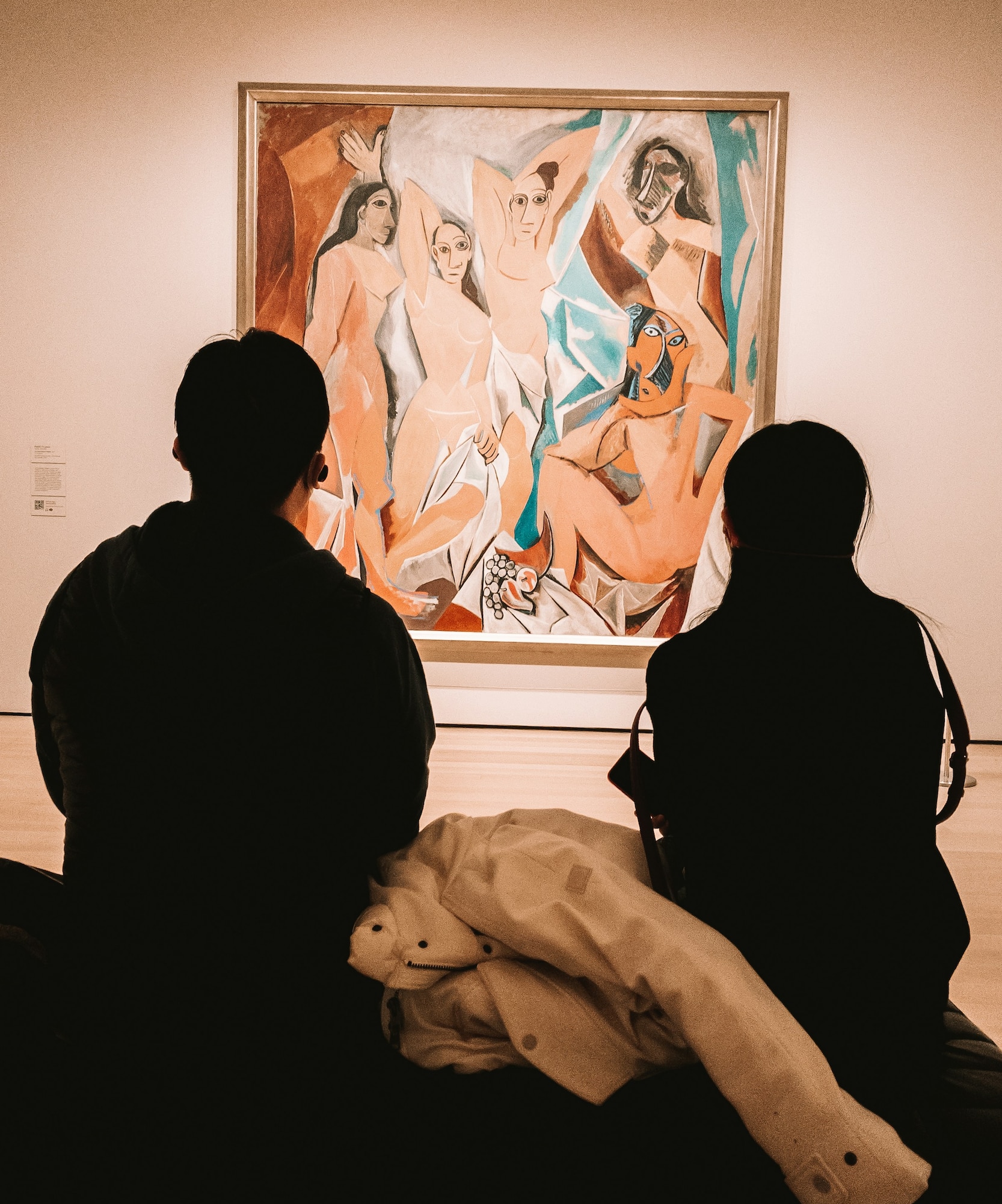 a group of people looking at a painting