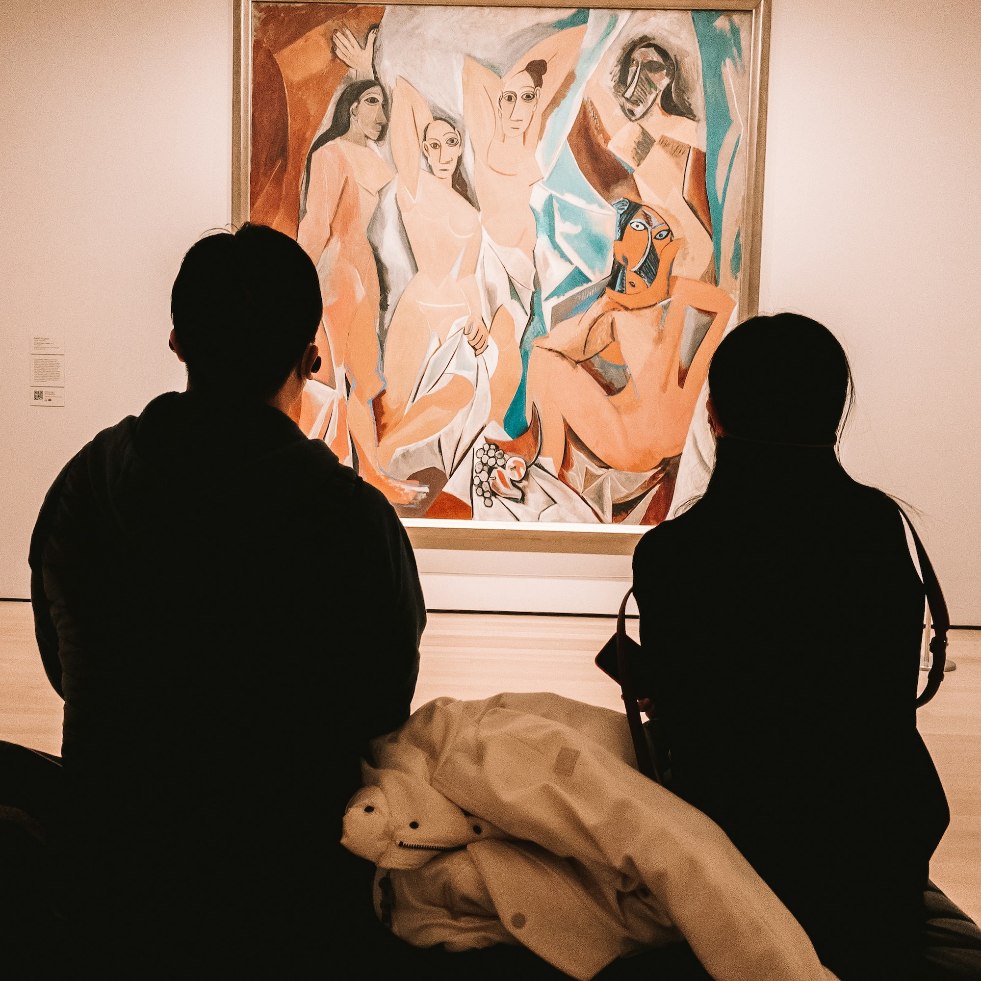 a group of people looking at a painting