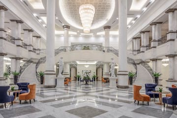 a large hall with marble floor and marble stairs