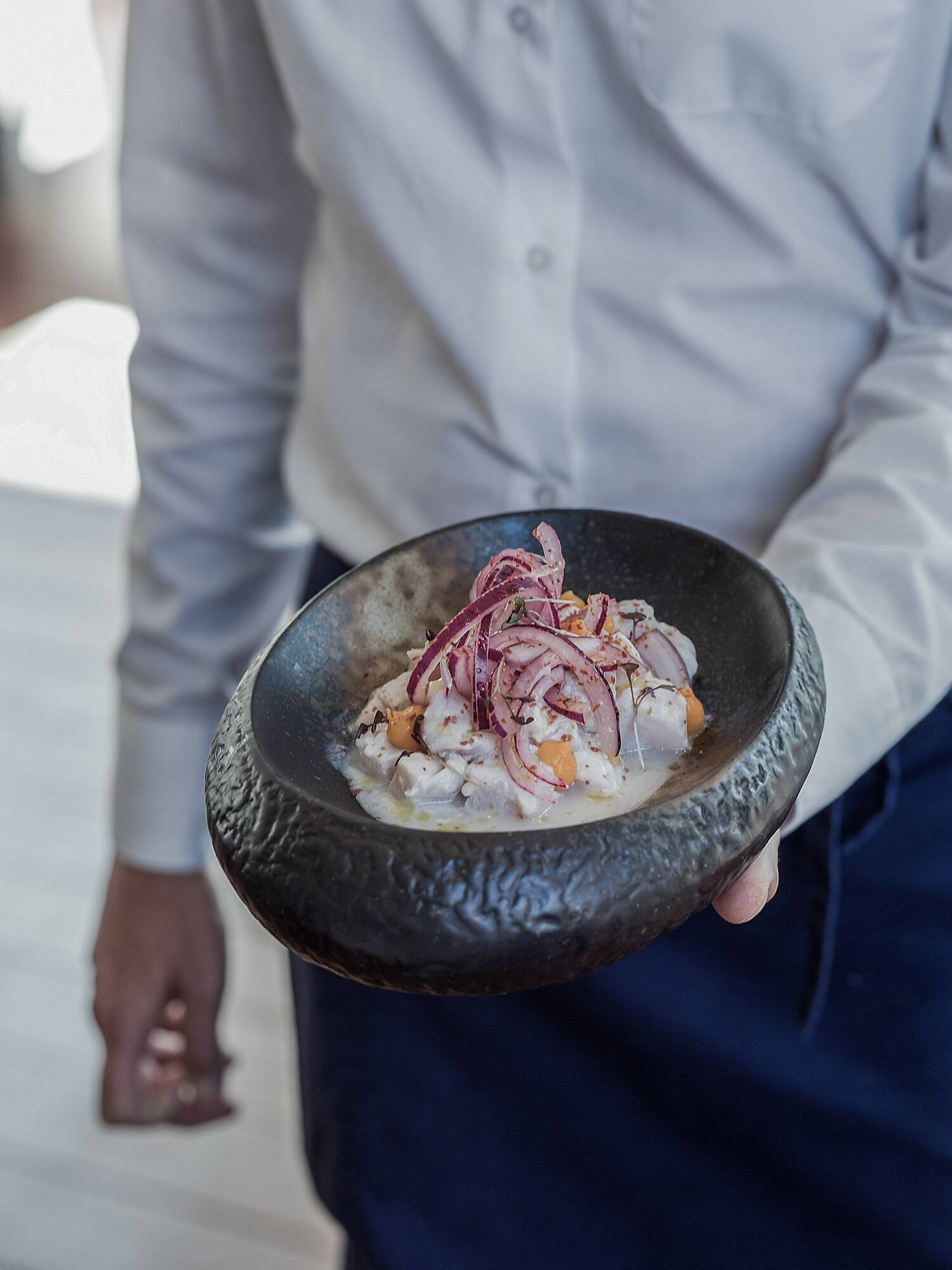 a person holding a bowl of food