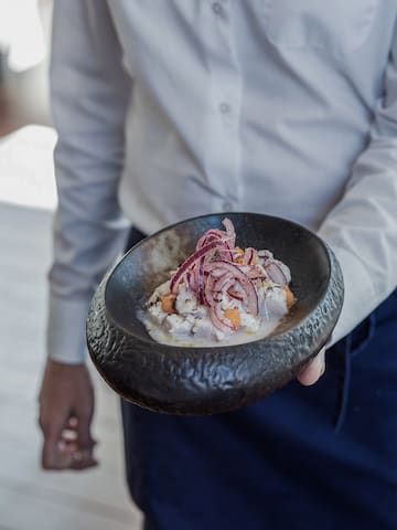 a person holding a bowl of food