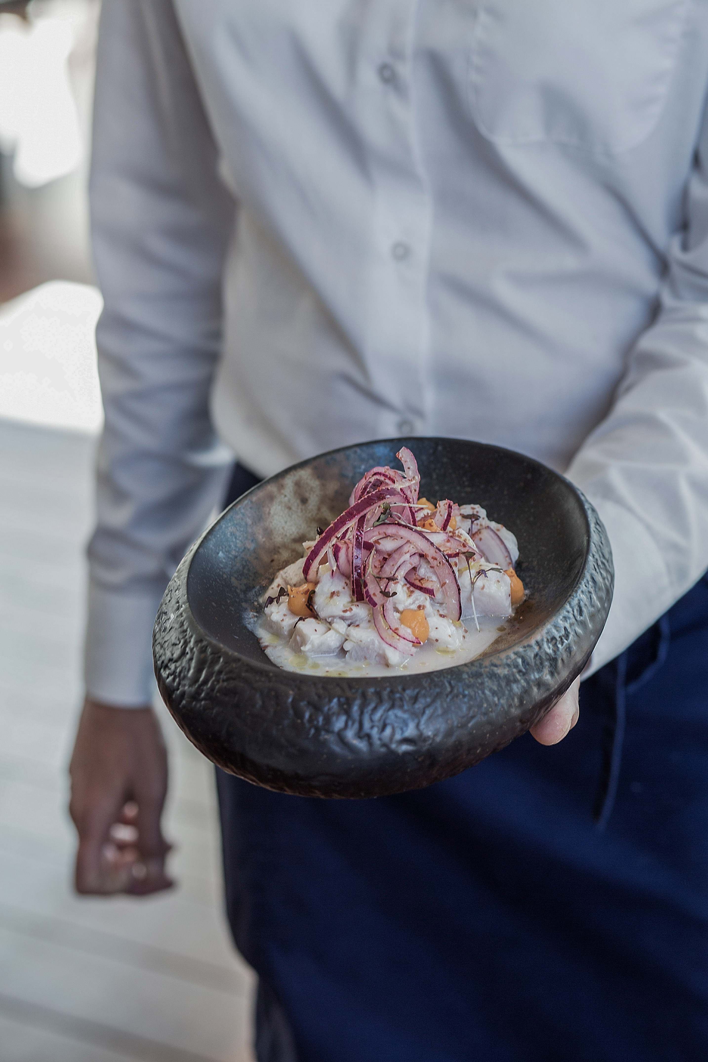 a person holding a bowl of food