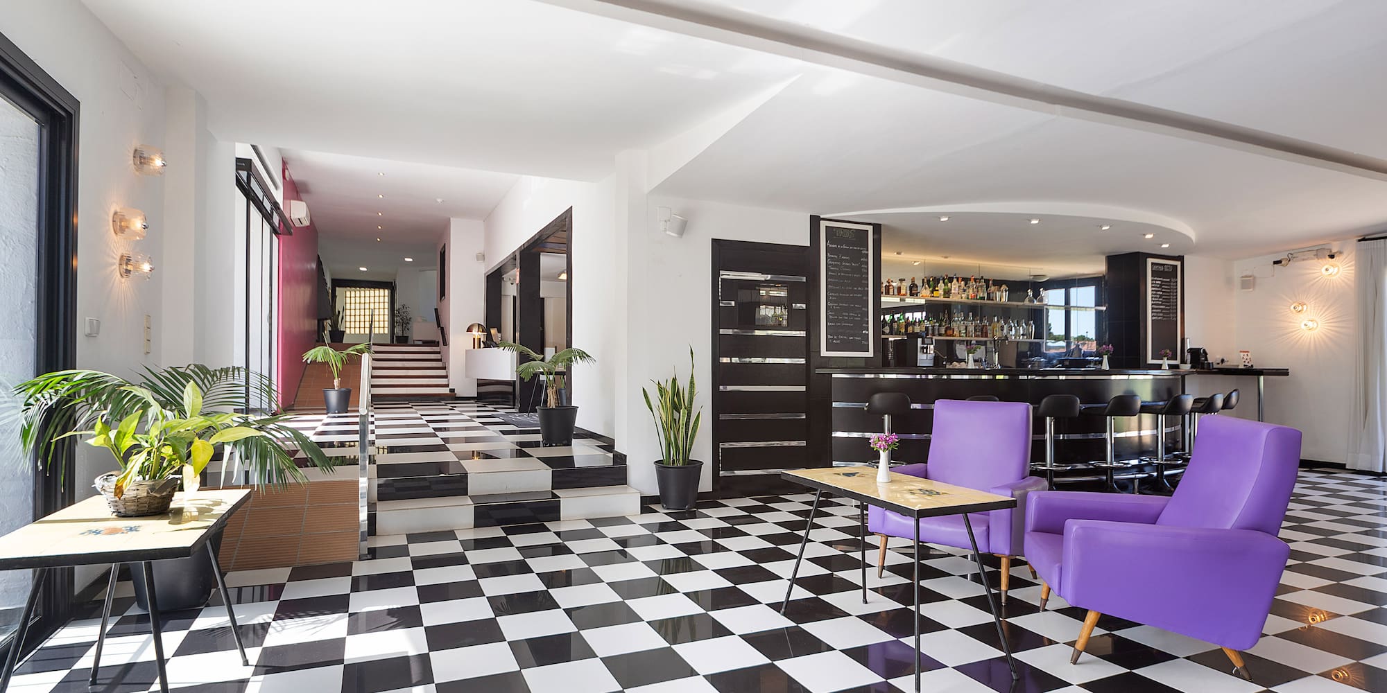 a room with purple chairs and a checkered floor