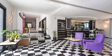 a room with purple chairs and a checkered floor