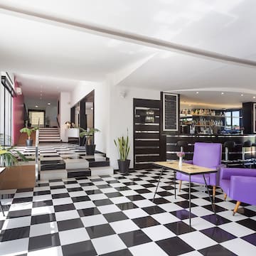 a room with purple chairs and a checkered floor