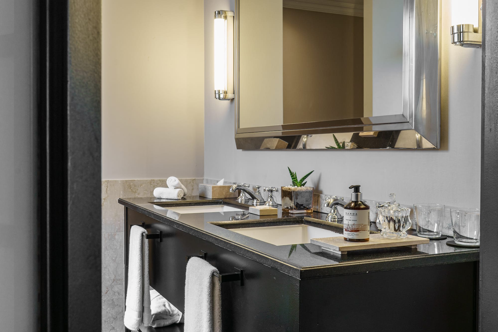 a bathroom with a mirror and a black vanity