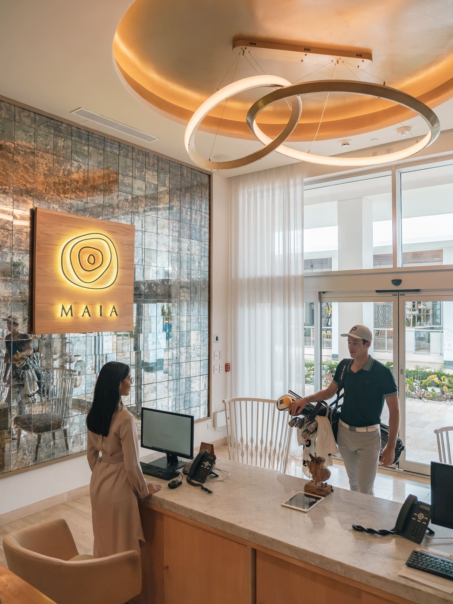 a man standing at a counter in a lobby