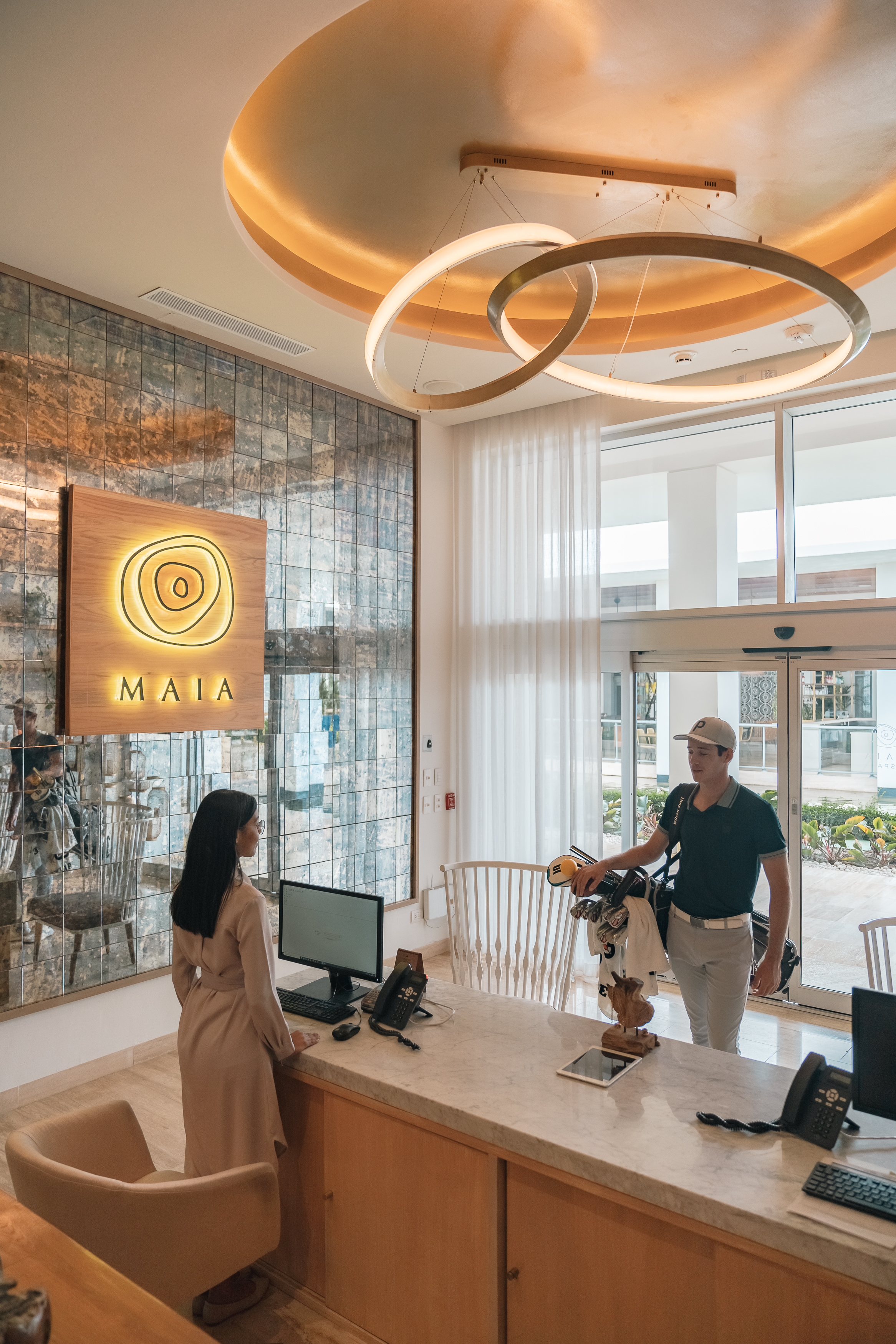 a man standing at a counter in a lobby