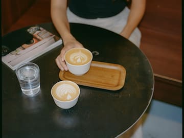 a woman holding a cup of coffee