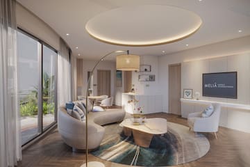 a living room with a round table and couches