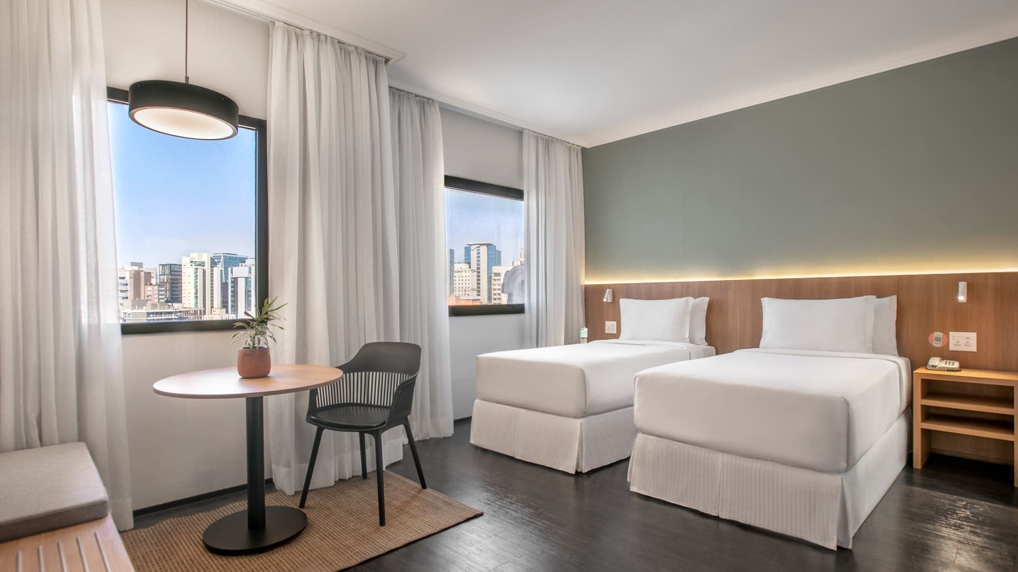 a room with two beds and a table