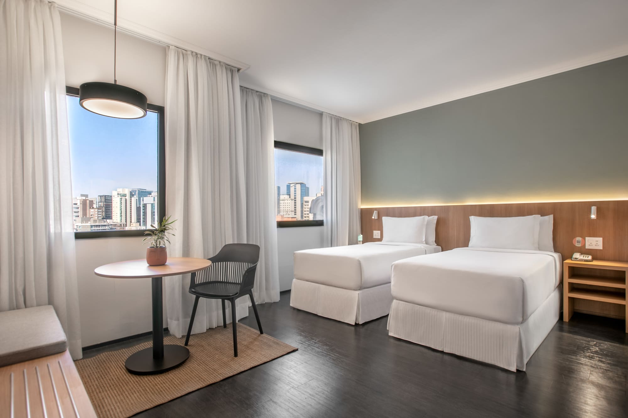 a room with two beds and a table