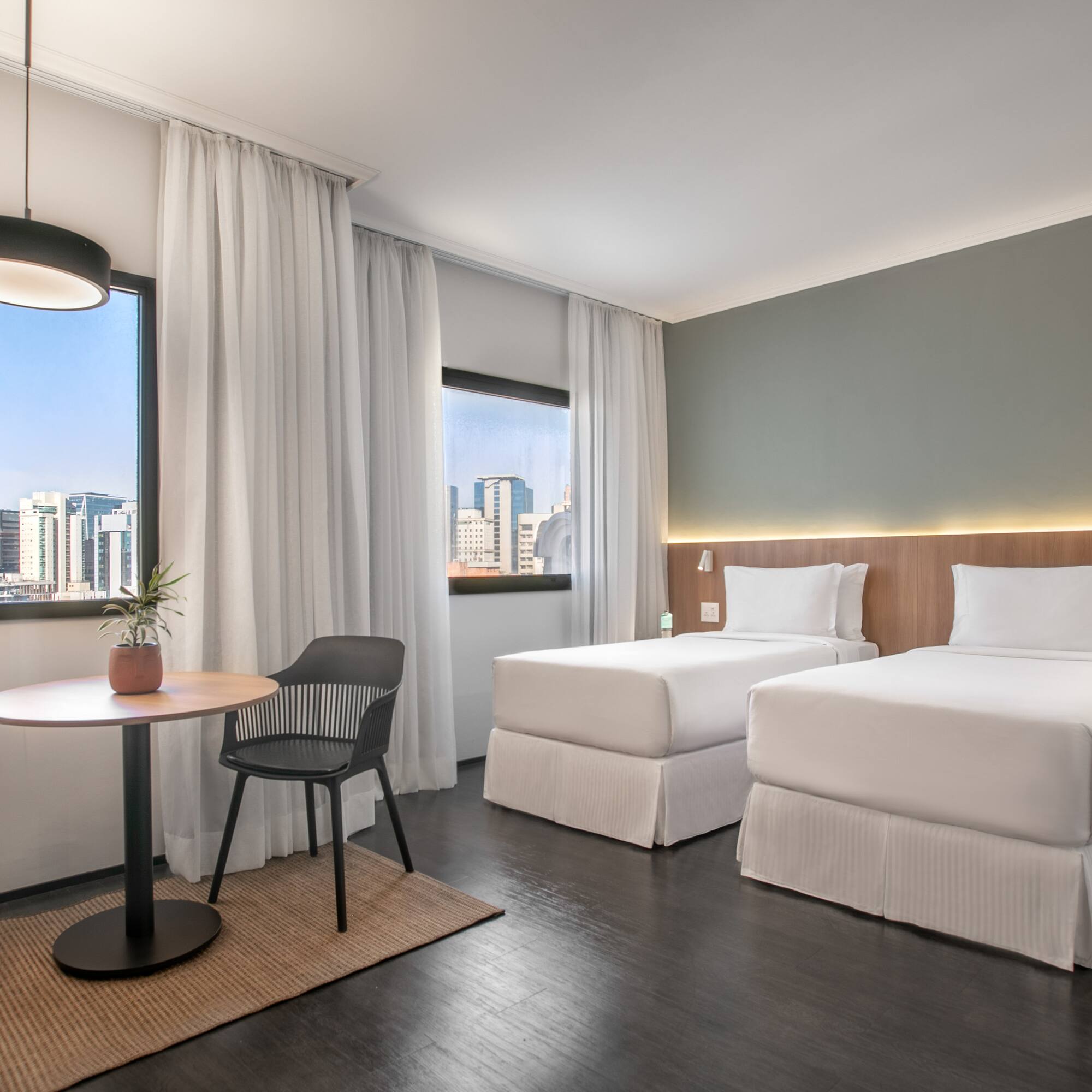 a room with two beds and a table