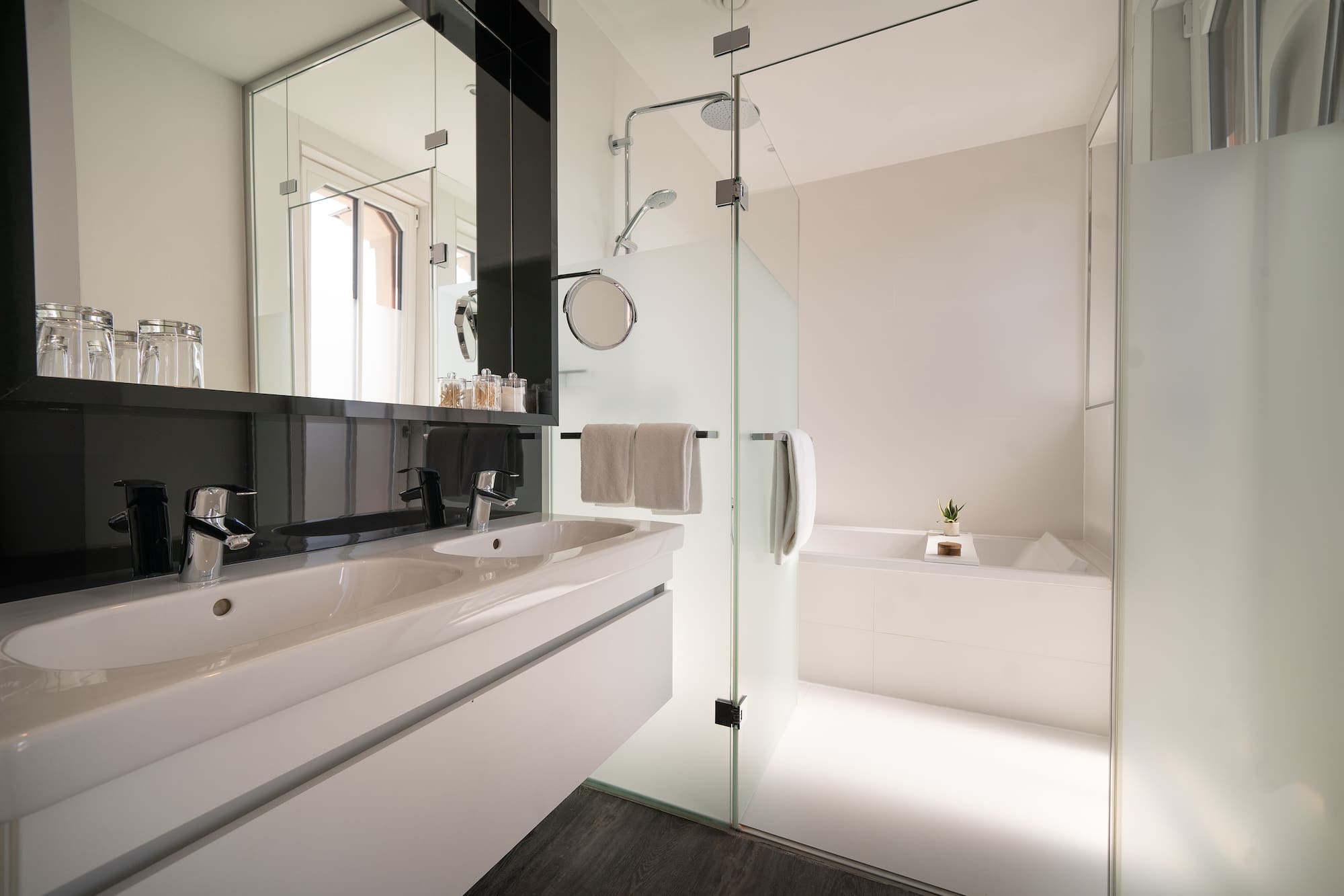 a bathroom with a glass shower door