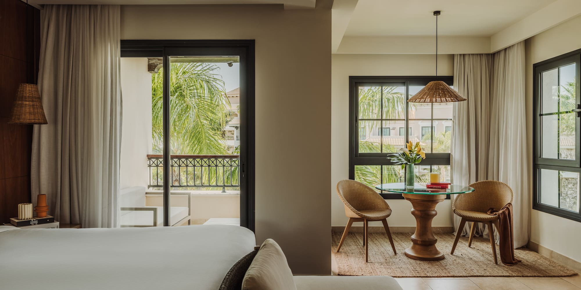 a room with a bed and chairs and a table