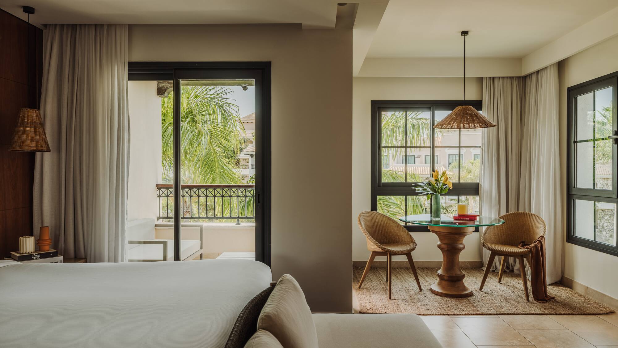 a room with a bed and chairs and a table