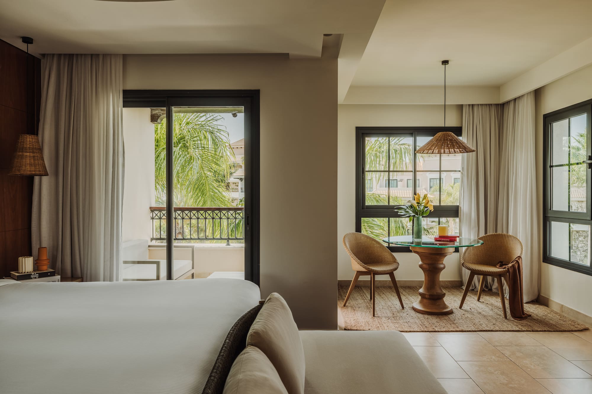 a room with a bed and chairs and a table