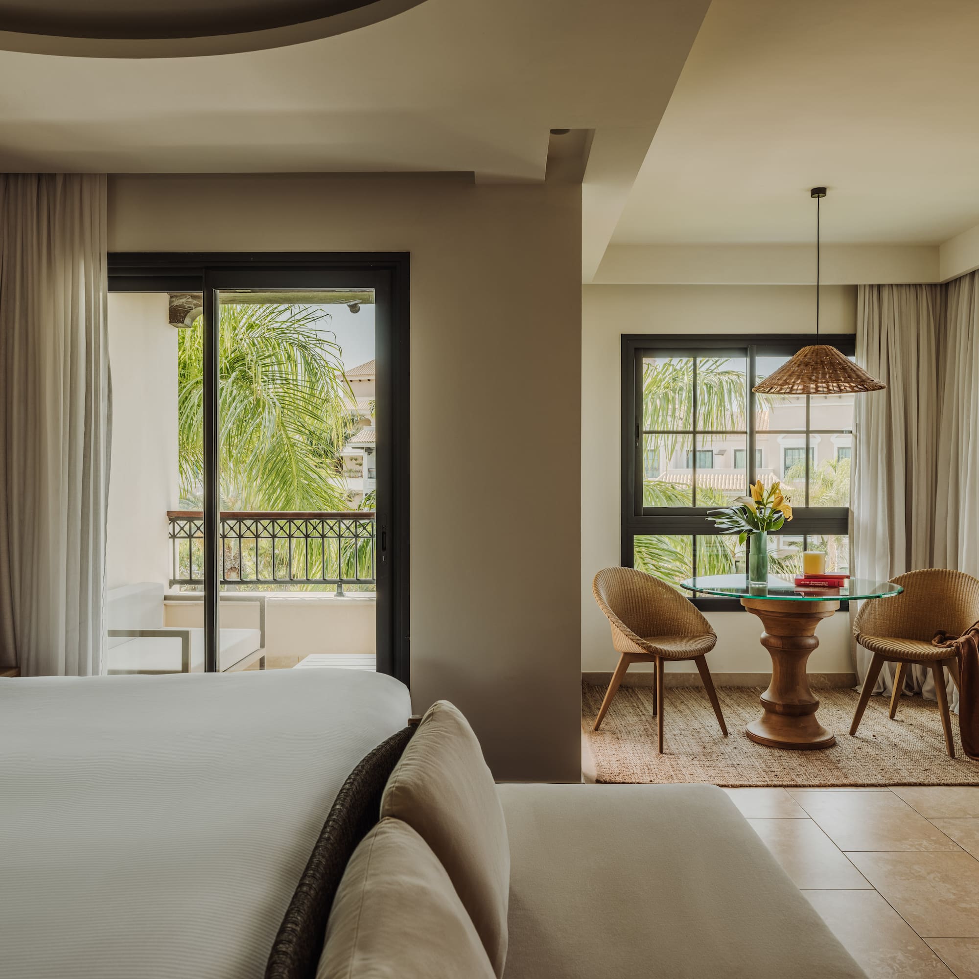 a room with a bed and chairs and a table