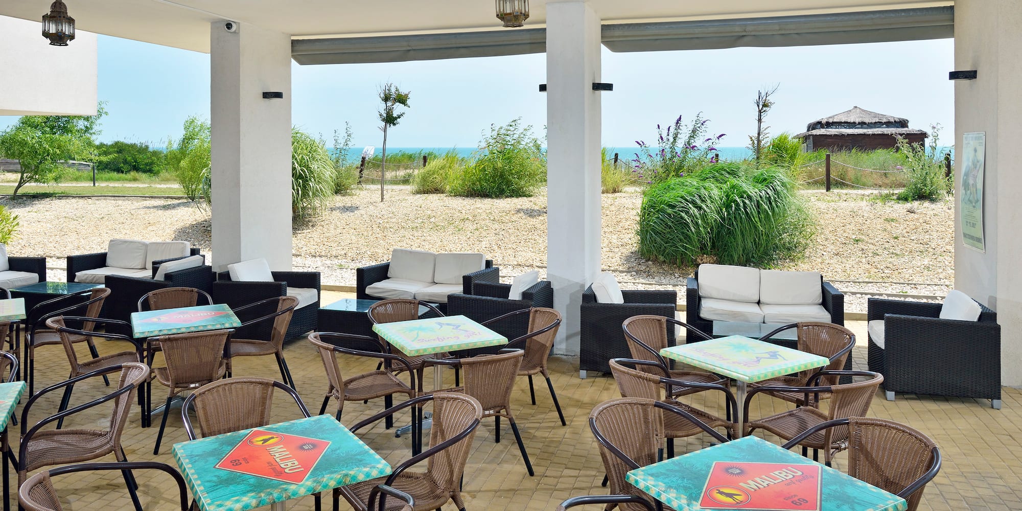 a patio with tables and chairs