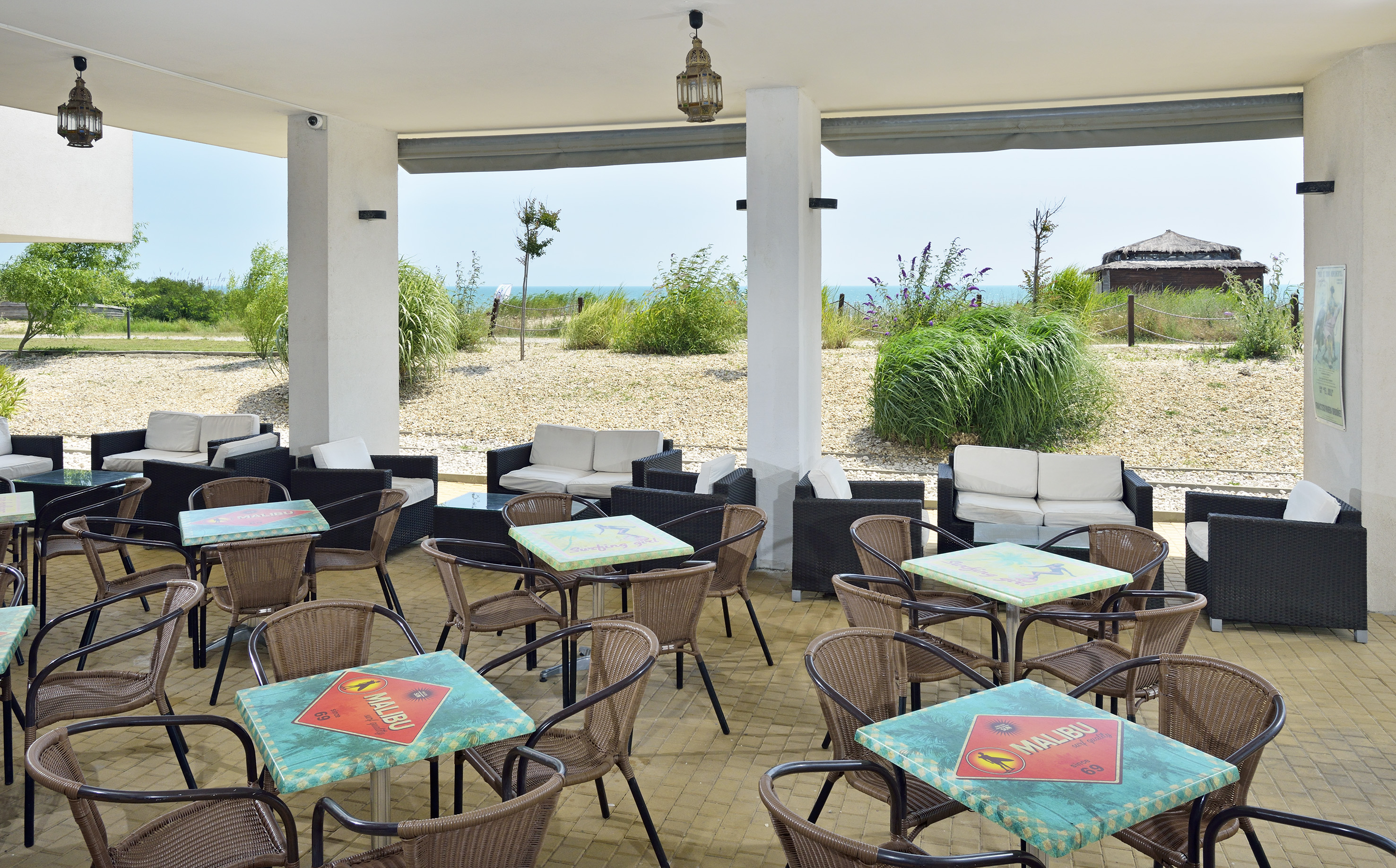 a patio with tables and chairs