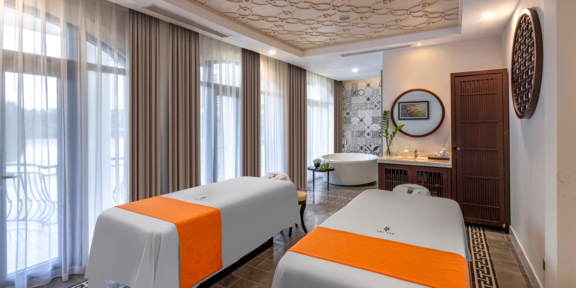 a room with two beds and a tub