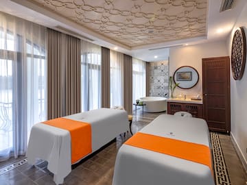 a room with two beds and a tub