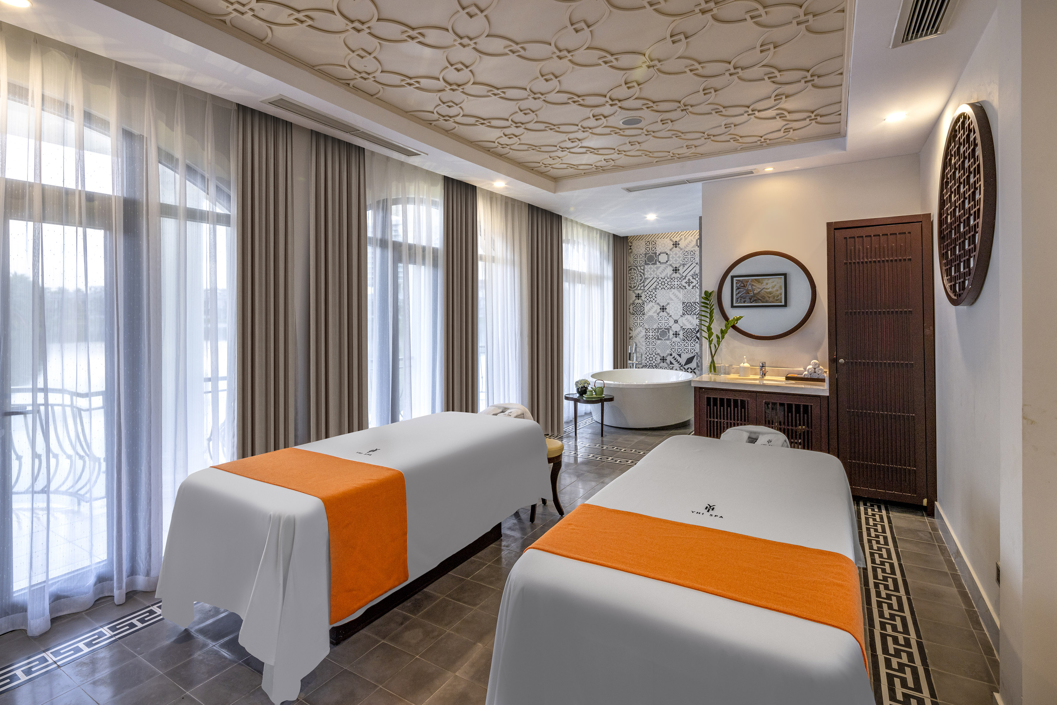 a room with two beds and a tub