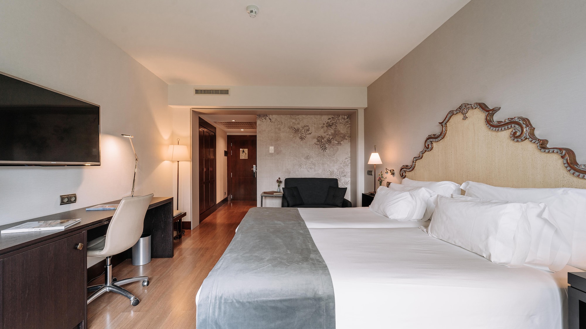 a room with a bed and a desk