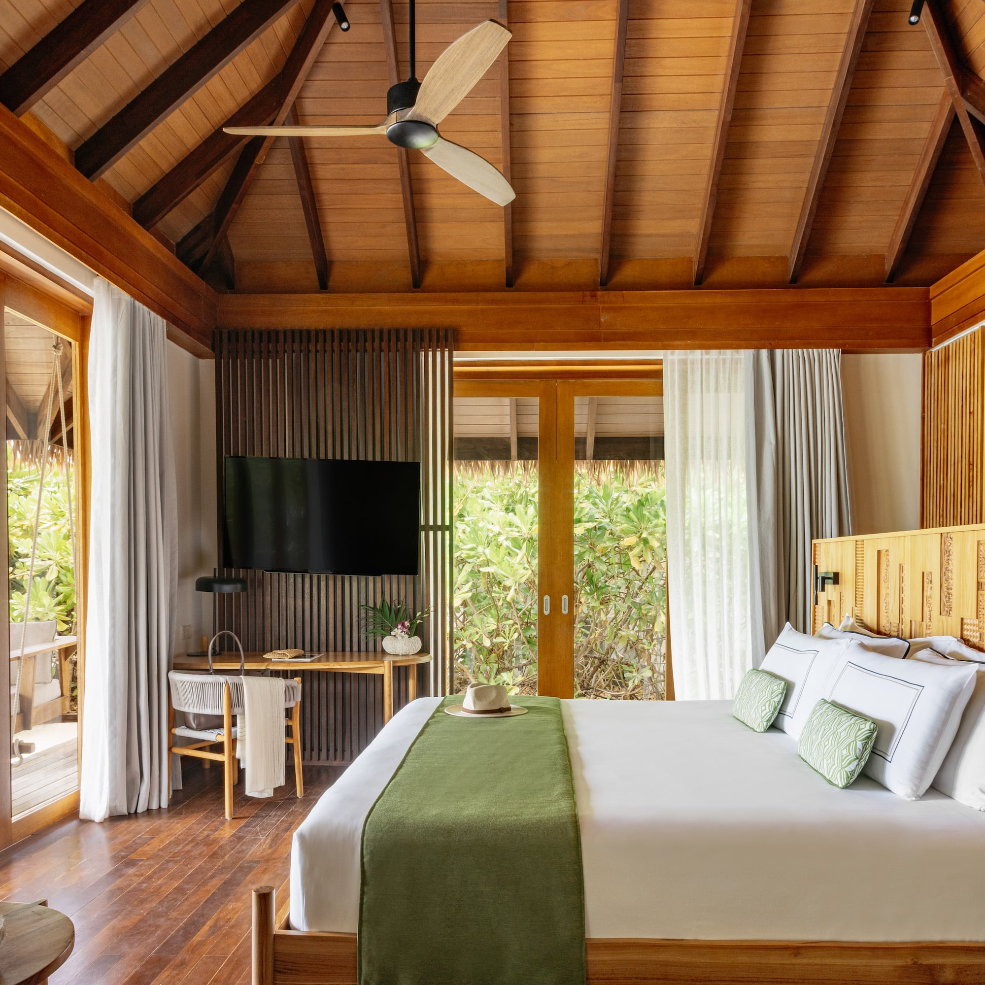 a room with a bed and a television