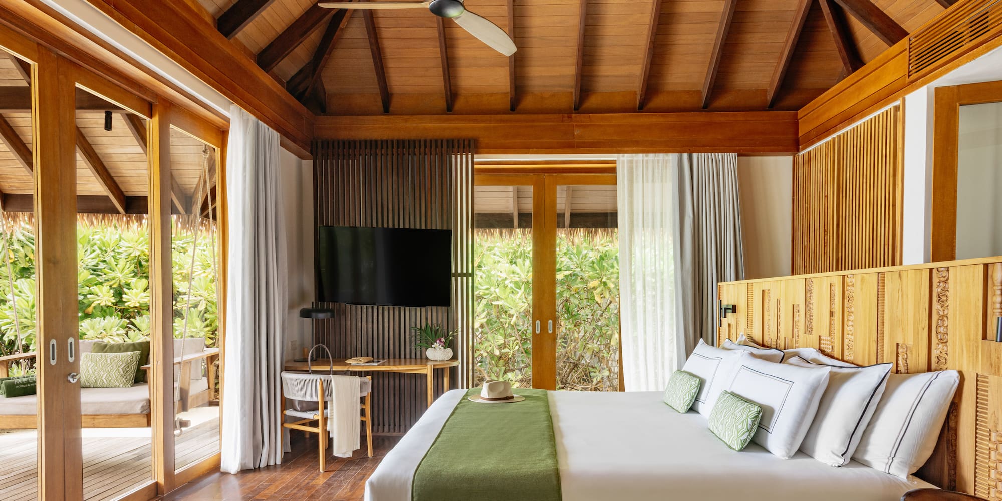 a room with a bed and a television