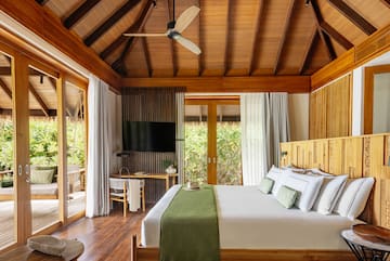 a room with a bed and a television