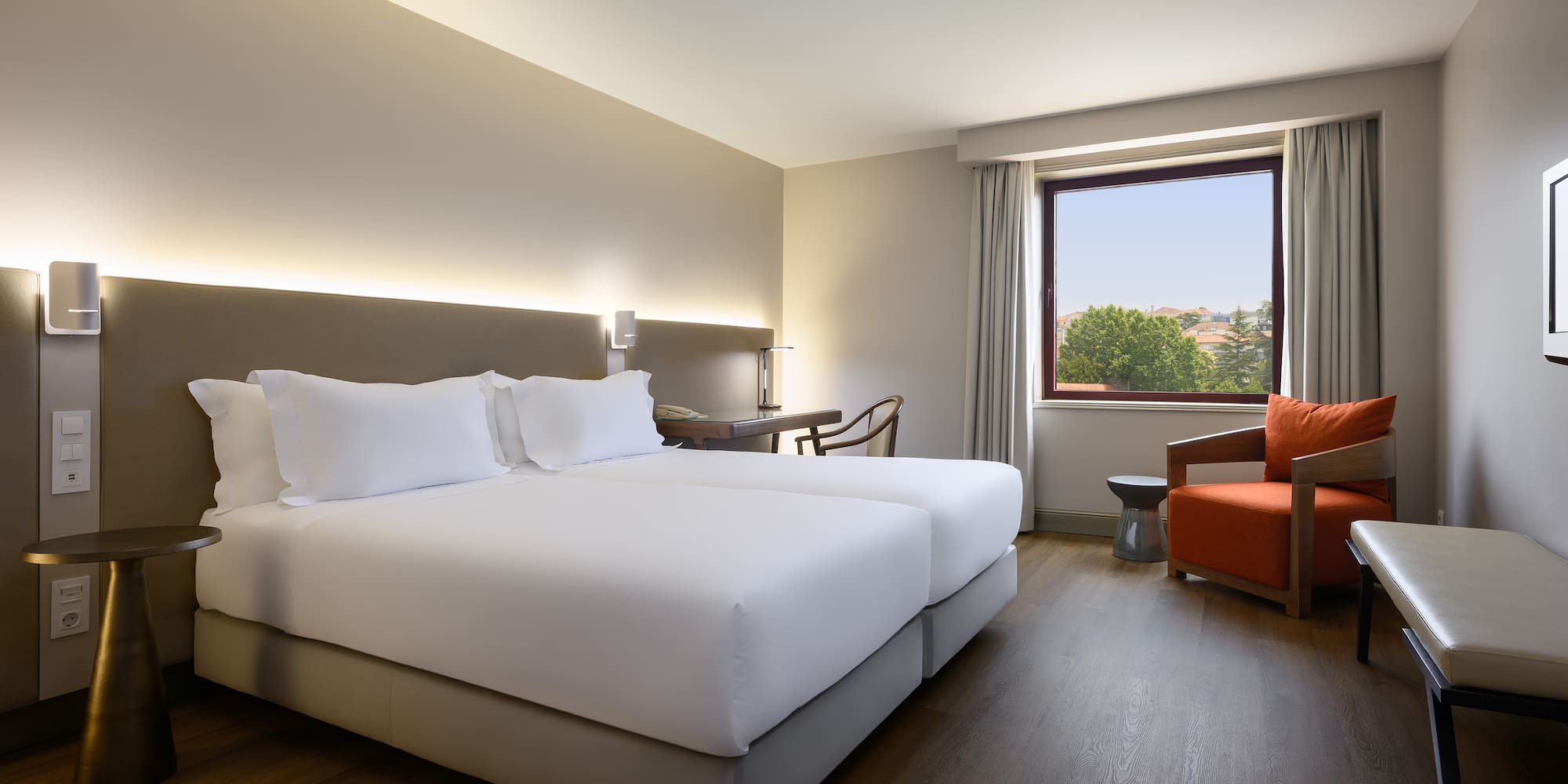 a room with two beds and a chair