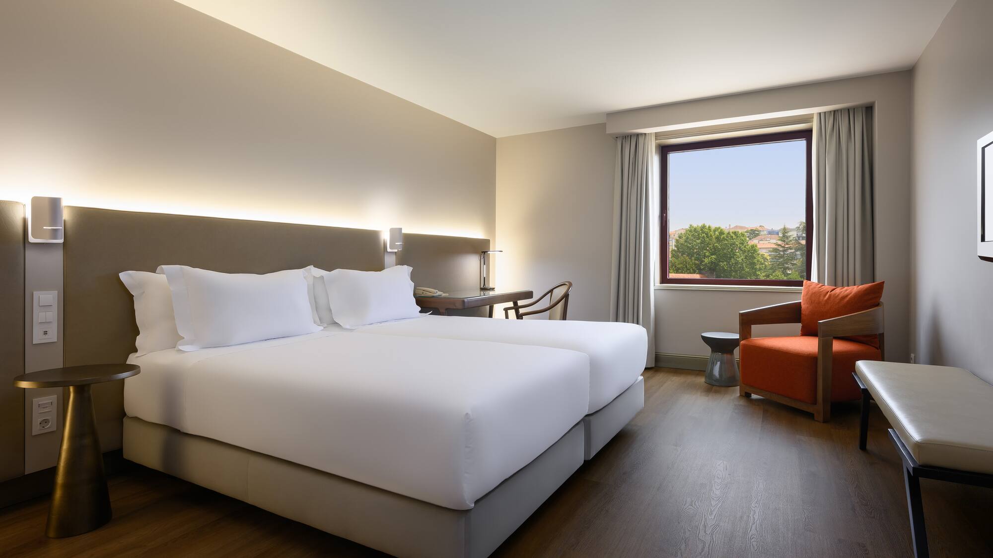 a room with two beds and a chair