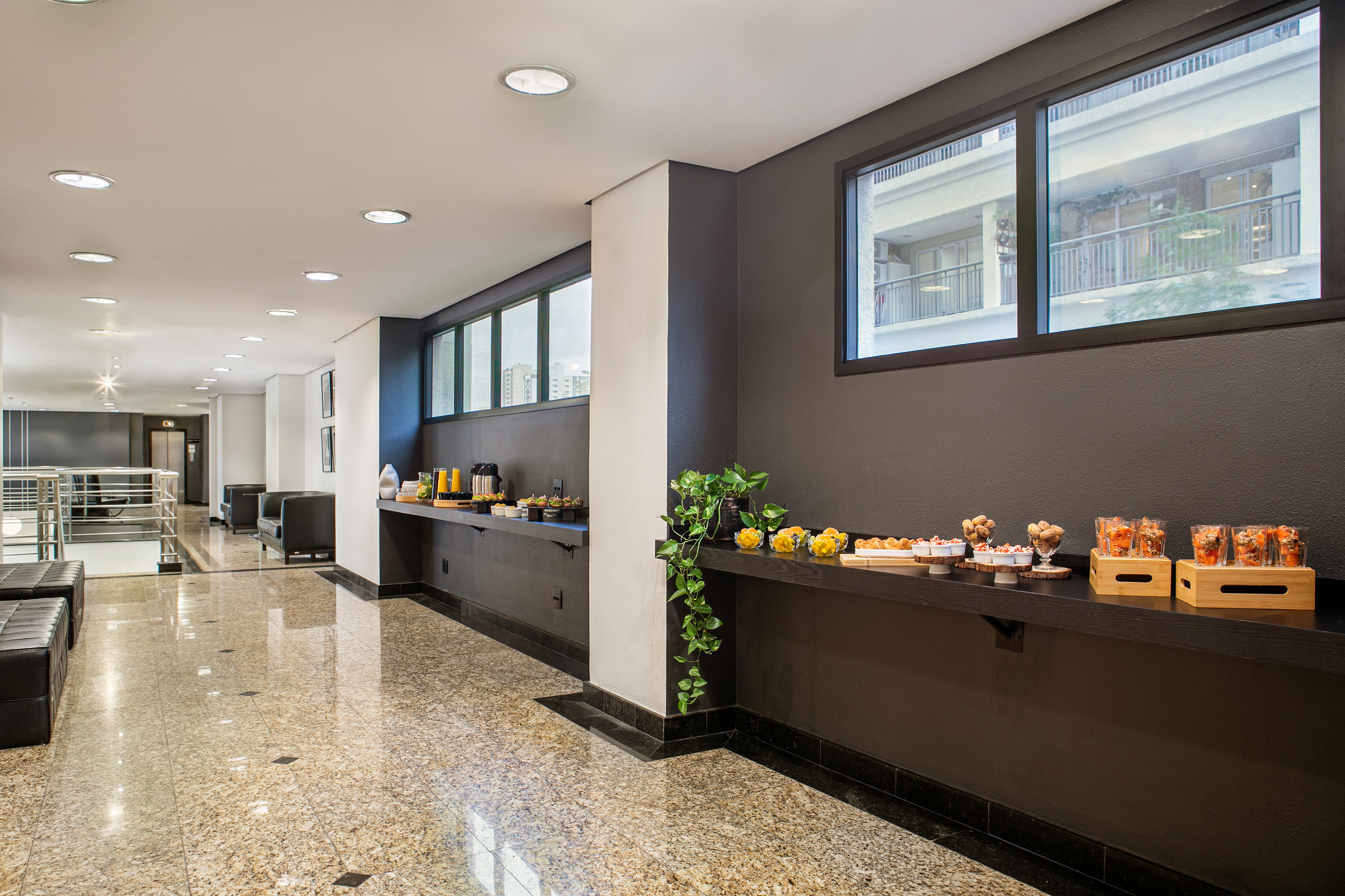Modern hotel lobby with snack bar, refreshments, and comfortable seating area.