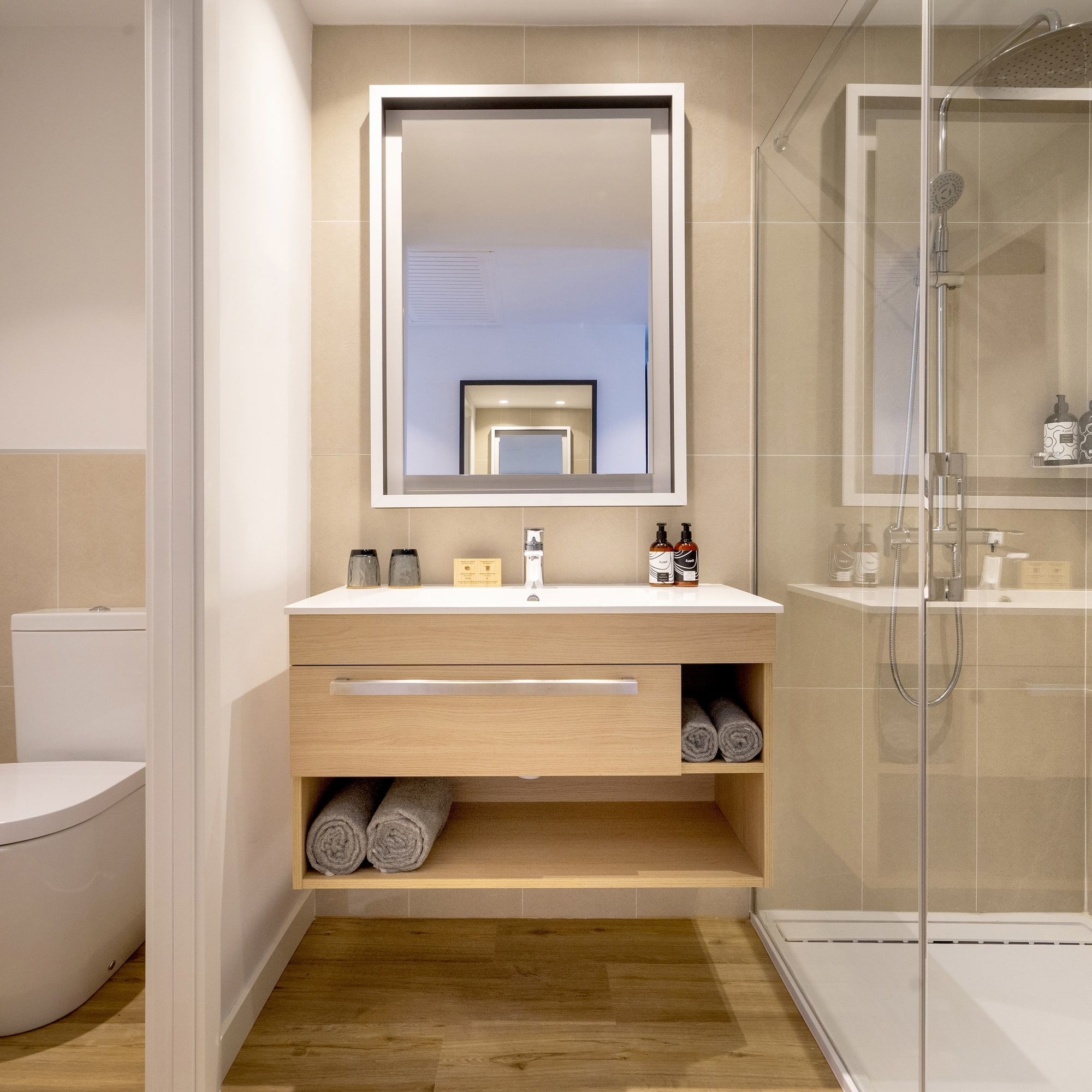 a bathroom with a mirror and a toilet