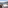 Winter balcony, white outdoor table & chairs, snowy mountain valley view.