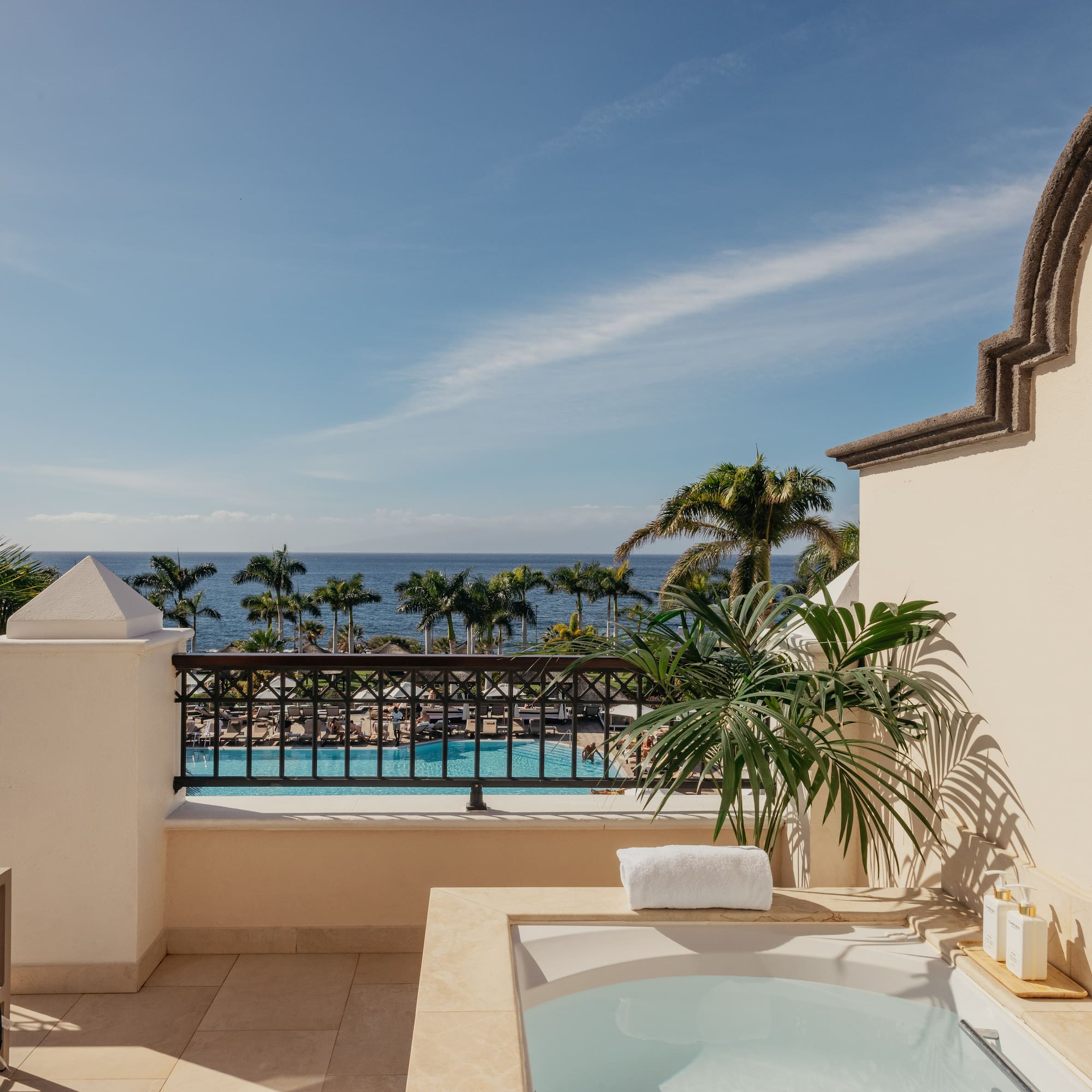 a hot tub on a balcony overlooking a body of water
