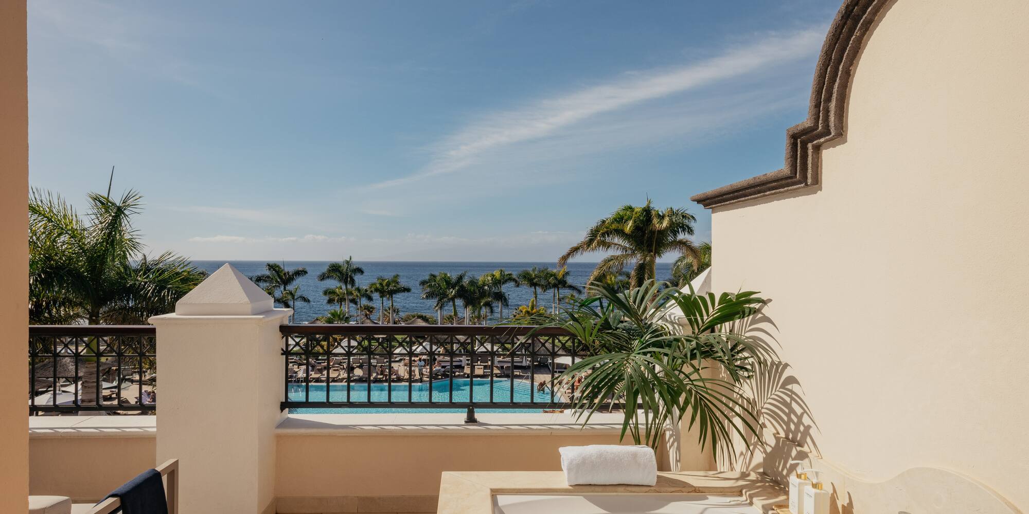 a hot tub on a balcony overlooking a body of water