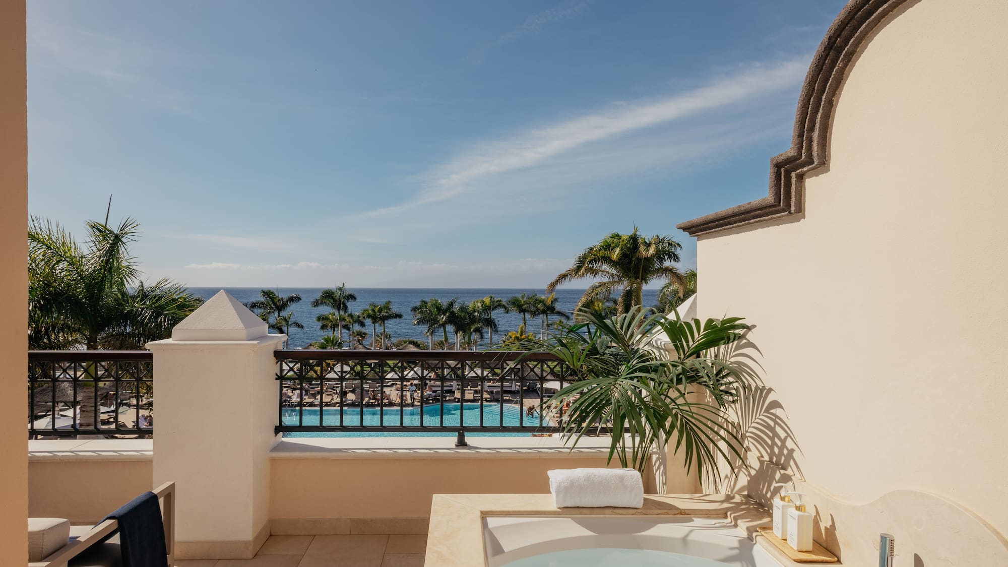 a hot tub on a balcony overlooking a body of water