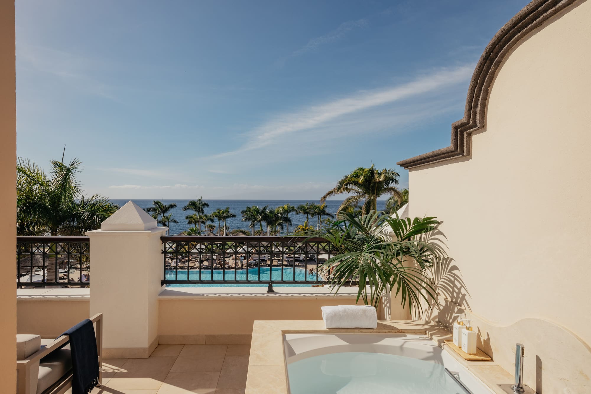 a hot tub on a balcony overlooking a body of water