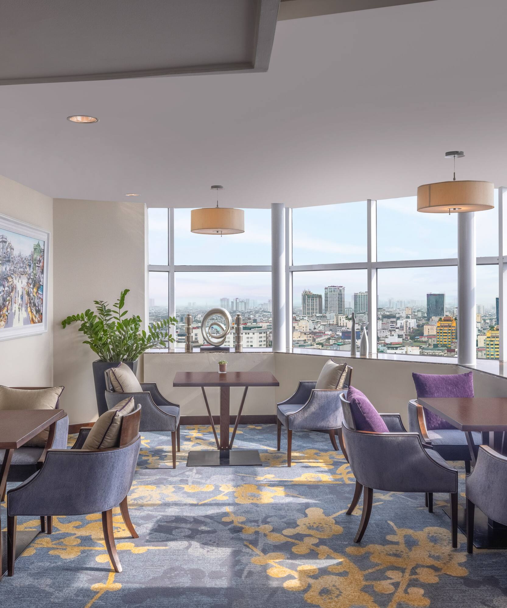a room with tables and chairs and a view of a city