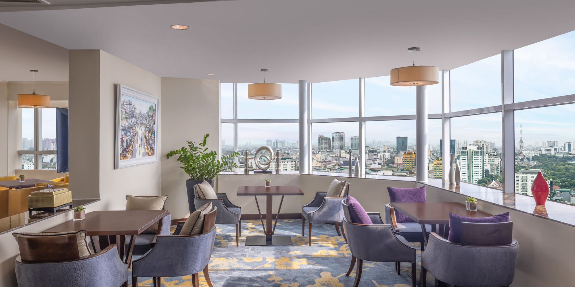 a room with tables and chairs and a view of a city