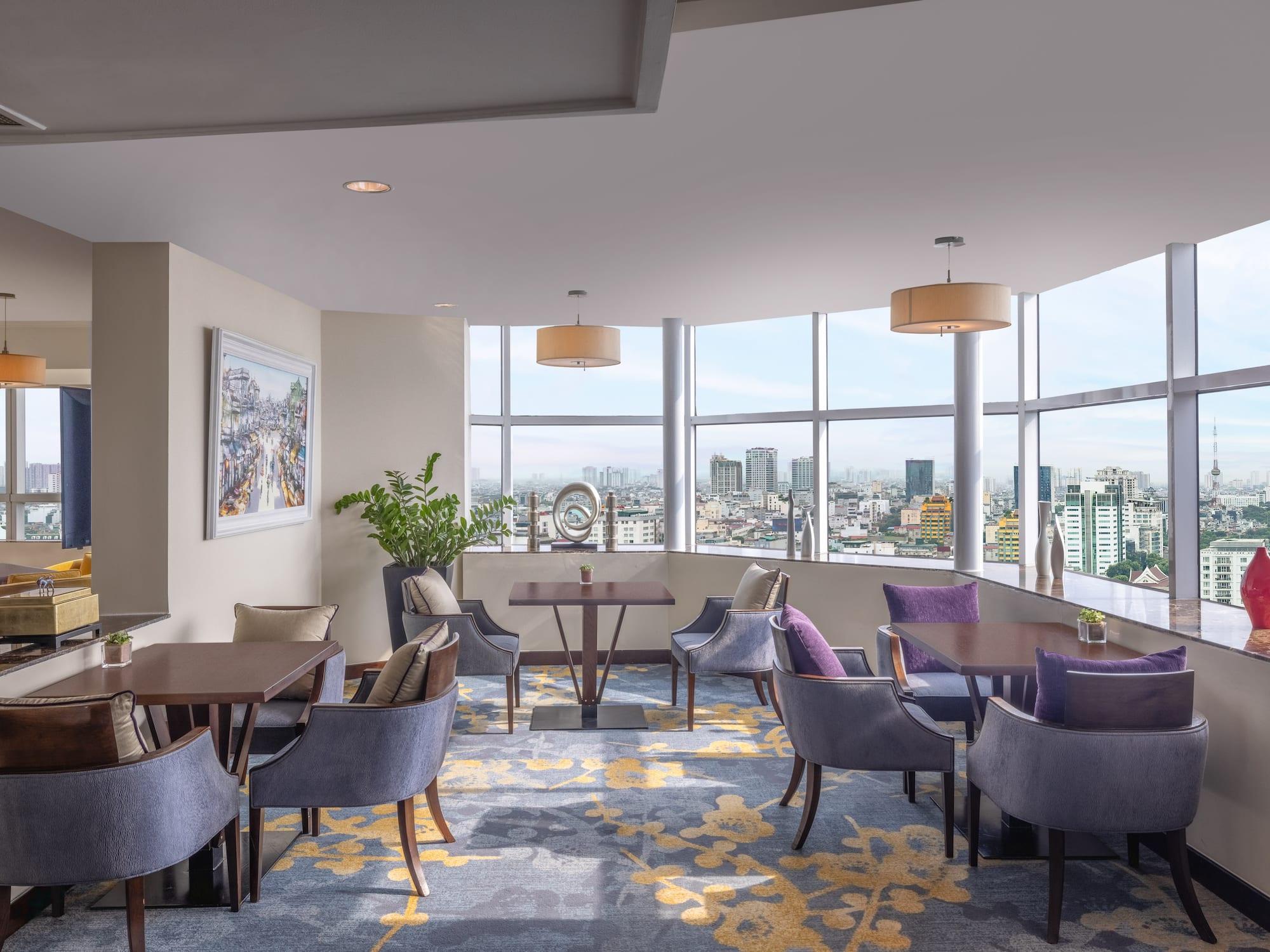 a room with tables and chairs and a view of a city