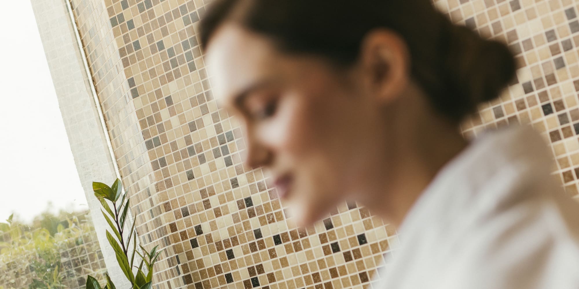 a woman holding a glass of liquid